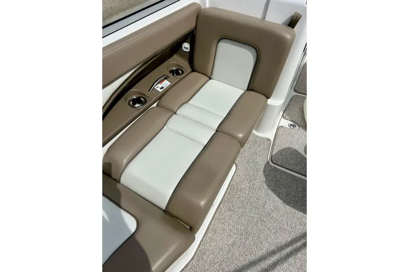 Slide: The Image of 2008 Searay SX 232 boat interior with beige and white cushioned seating. - 11