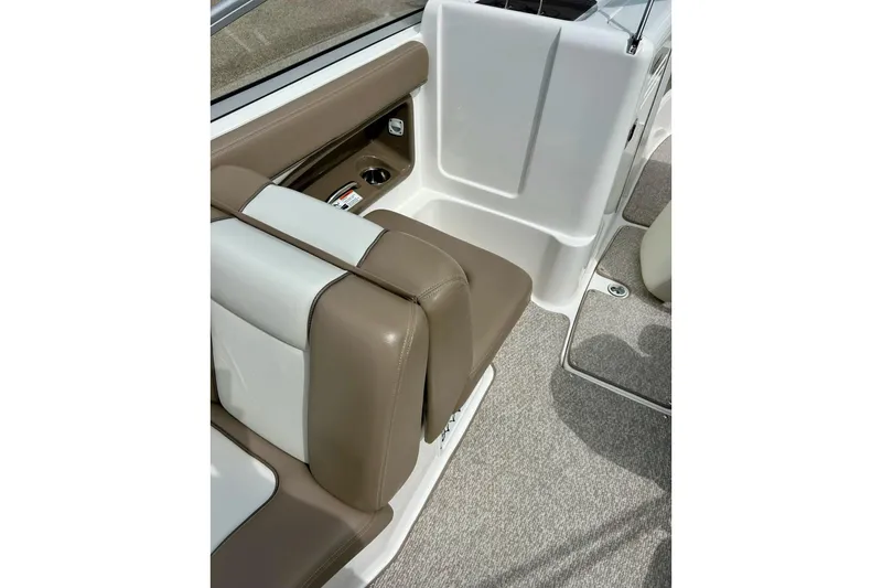 Slide: The Image of 2008 Searay SX 232 boat interior with brown and white seating. - 12