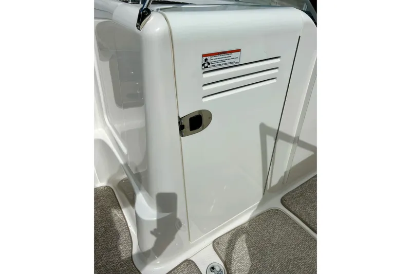 Slide: The Image of 2008 Searay SX 232 boat interior with white compartment door and latch. - 15