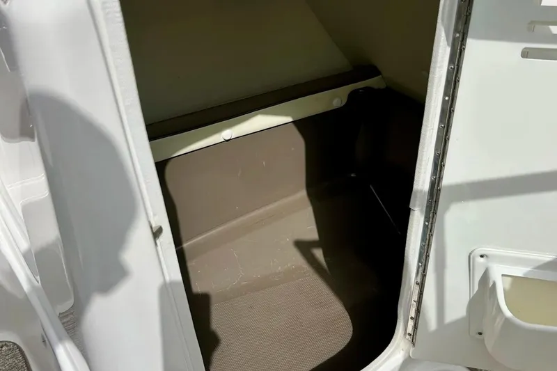 Slide: The Image of 2008 Searay SX 232 boat storage compartment interior, showing clean and spacious design. - 16