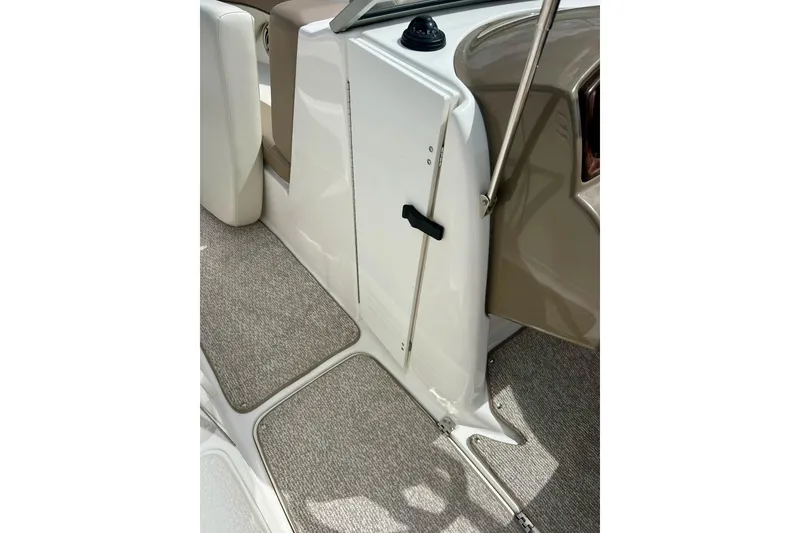 Slide: The Image of 2008 Searay SX 232 boat interior with beige carpet and white paneling. - 17