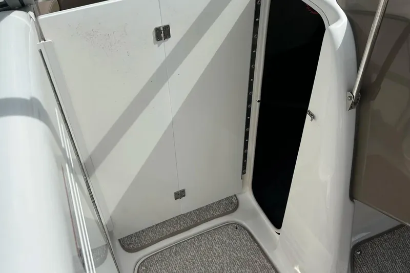 Slide: The Image of 2008 Searay SX 232 boat interior with open storage compartment. - 18