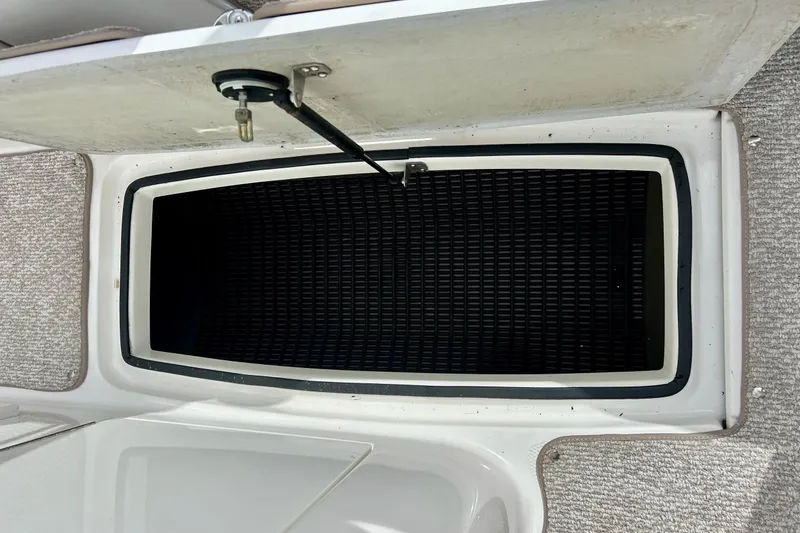 Slide: The Image of Open storage compartment on 2008 Searay SX 232 boat, featuring carpeted flooring. - 20