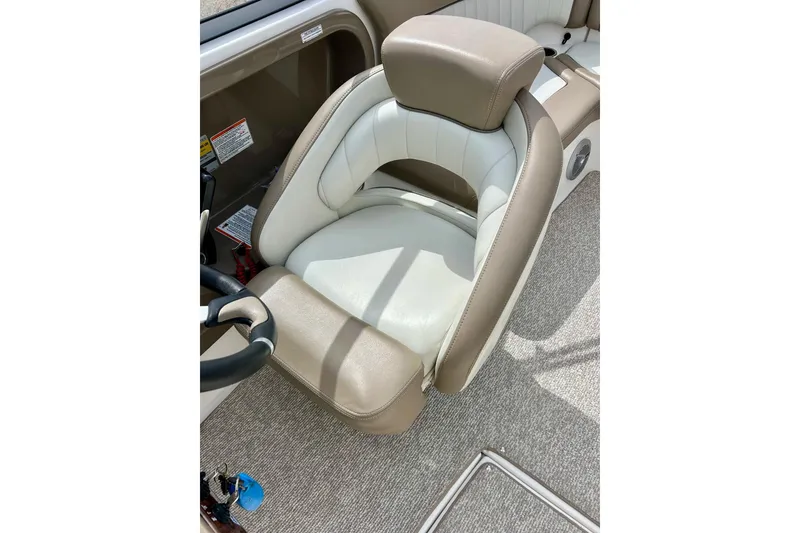Slide: The Image of 2008 Searay SX 232 boat interior with beige and white captain's seat. - 21