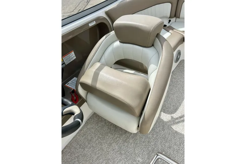 Slide: The Image of 2008 Searay SX 232 boat interior with beige and white cushioned seating. - 22