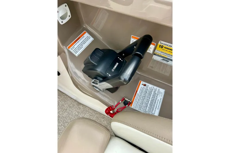 Slide: The Image of Control panel of 2008 Searay SX 232 boat with safety warnings and throttle lever. - 23