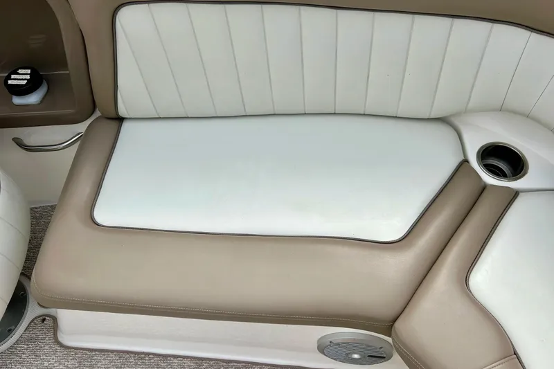 Slide: The Image of 2008 Searay SX 232 boat interior seating with beige and white upholstery. - 27