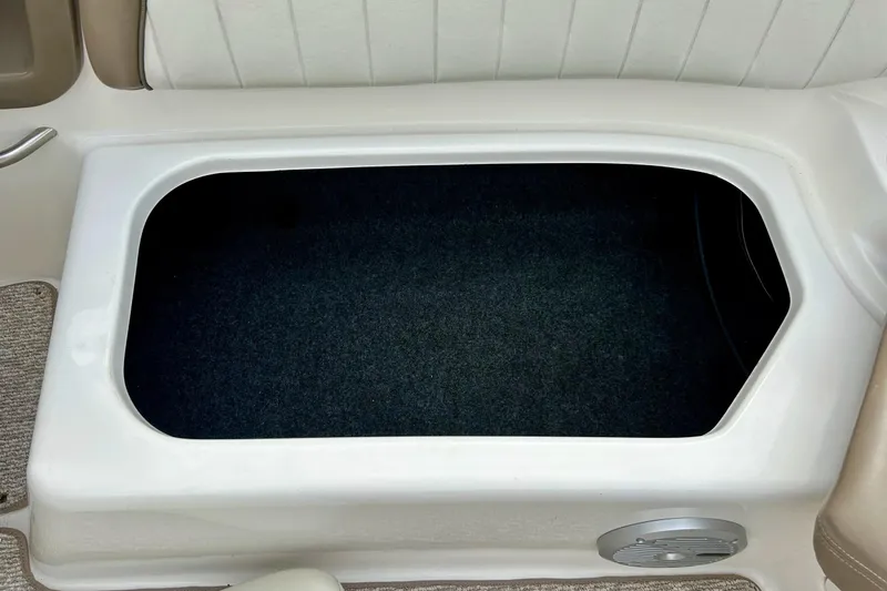 Slide: The Image of Storage compartment in 2008 Searay SX 232 boat, featuring carpeted interior. - 28