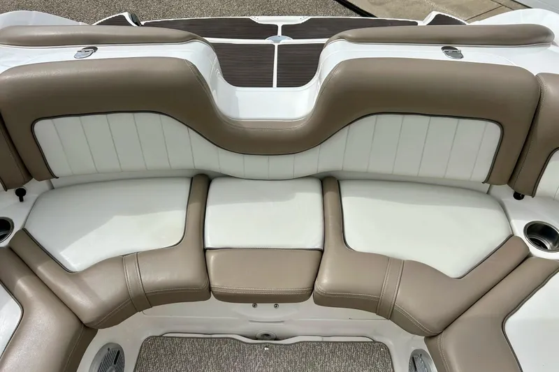 Slide: The Image of 2008 Searay SX 232 boat interior with beige and white cushioned seating. - 29