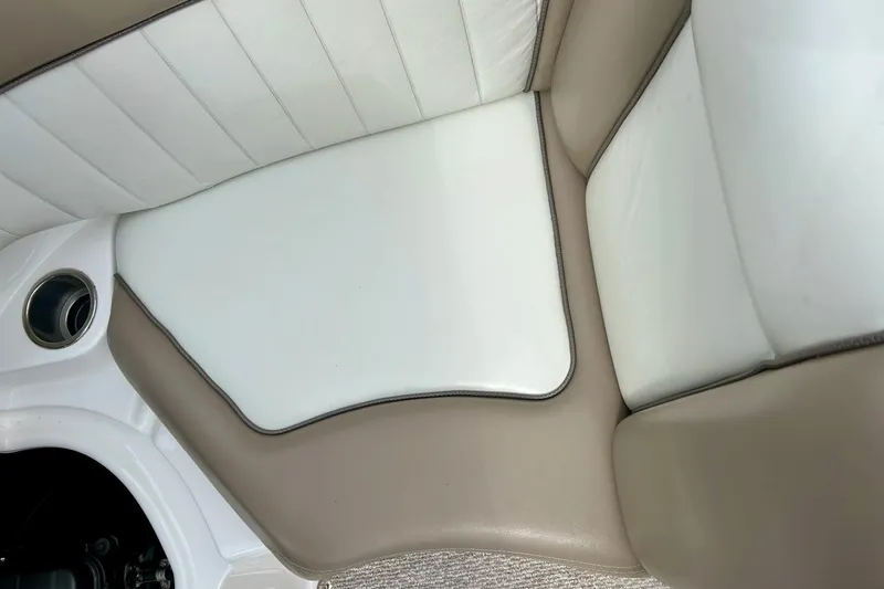 Slide: The Image of 2008 Searay SX 232 boat interior with white and beige seating. - 31