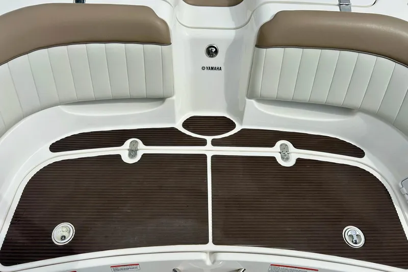 Slide: The Image of 2008 Searay SX 232 boat interior with brown and white seating and deck. - 35