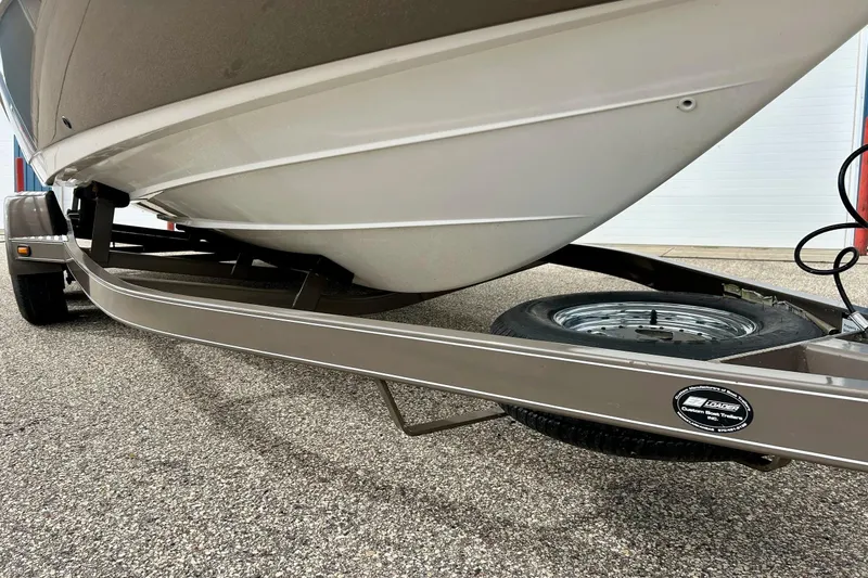 Slide: The Image of 2008 Searay SX 232 boat on trailer, close-up view of hull and wheel. - 38