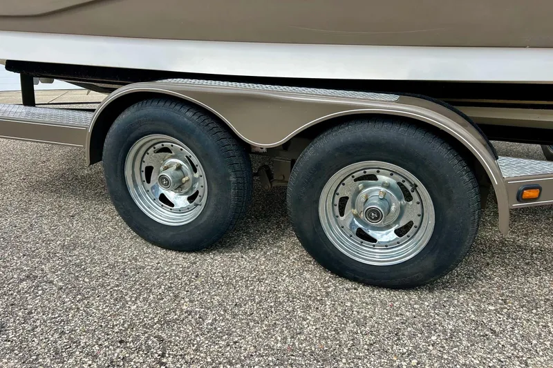 Slide: The Image of 2008 Searay SX 232 trailer wheels on asphalt surface. - 5
