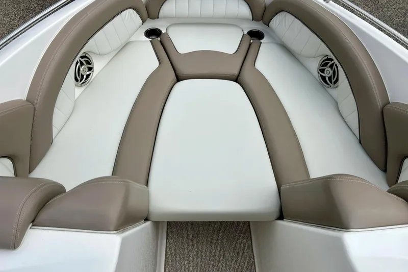 Slide: The Image of 2008 Searay SX 232 boat interior with beige and white cushioned seating. - 7