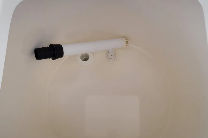 Slide: The Image of Livewell interior of 1997 Wellcraft 330 Coastal boat, featuring a drain and pipe. - 12
