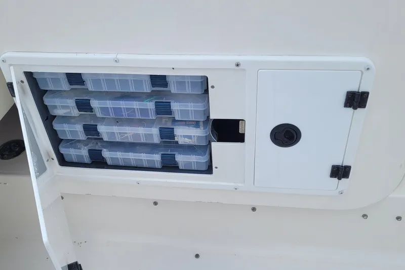 Slide: The Image of Storage compartment with tackle boxes on a 1997 Wellcraft 330 Coastal boat. - 14