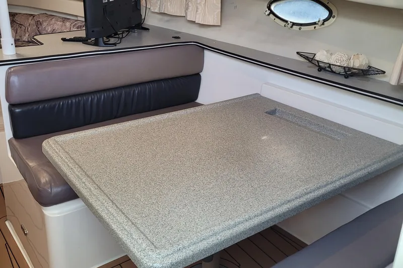 Slide: The Image of Interior of 1997 Wellcraft 330 Coastal boat with dining area and seating. - 20