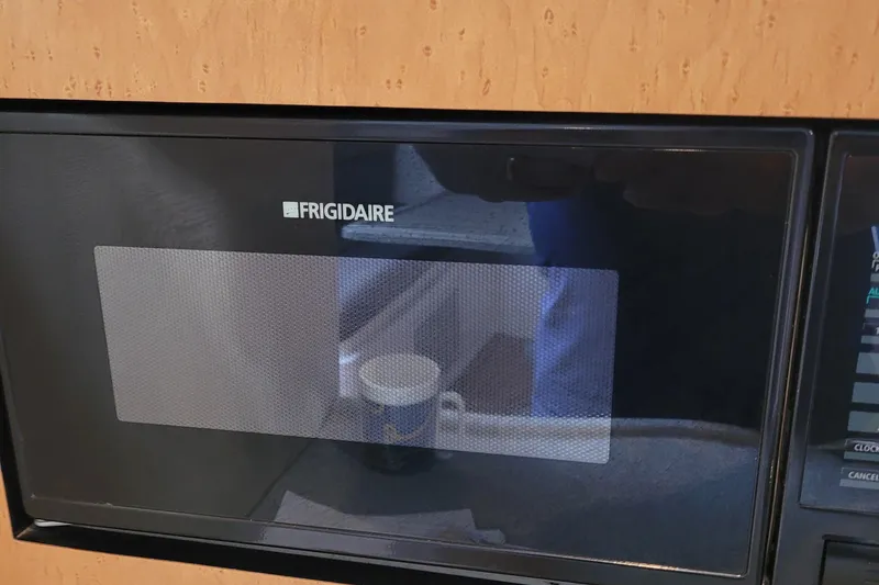 Slide: The Image of Frigidaire microwave inside a 1997 Wellcraft 330 Coastal boat kitchen area. - 23