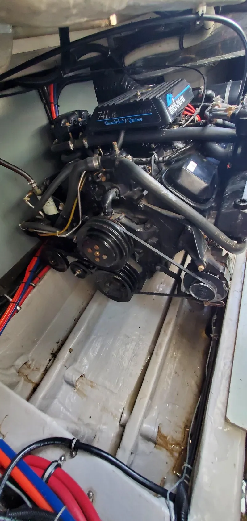 Slide: The Image of Engine compartment of a 1997 Wellcraft 330 Coastal boat, showcasing mechanical components. - 28