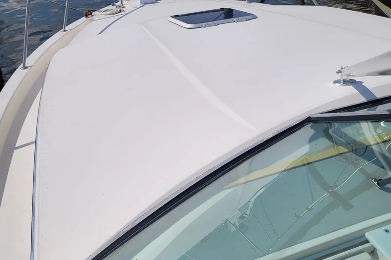 Slide: The Image of 1997 Wellcraft 330 Coastal boat deck with hatch, viewed from the bow. - 8
