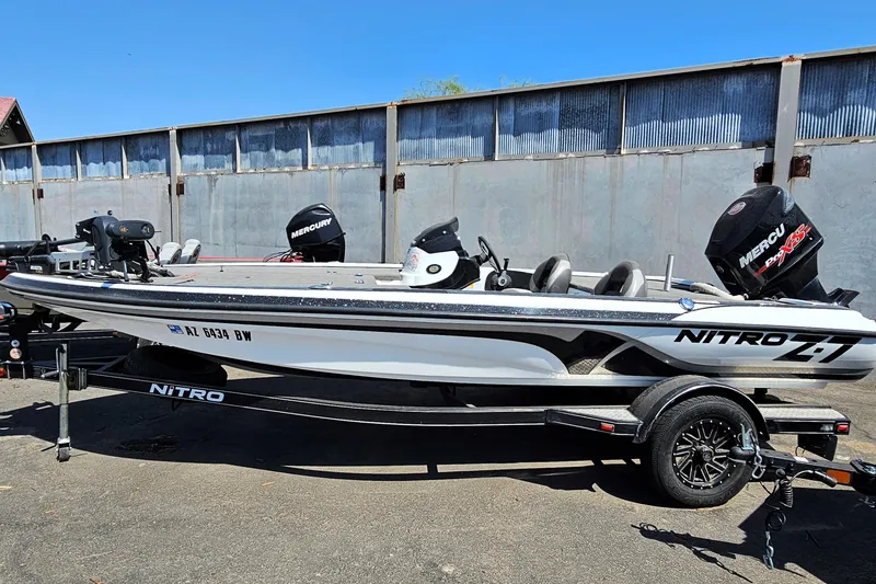 Slide: The Image of 2015 Nitro Z7 boat with Mercury engine on trailer, parked outdoors. - 2