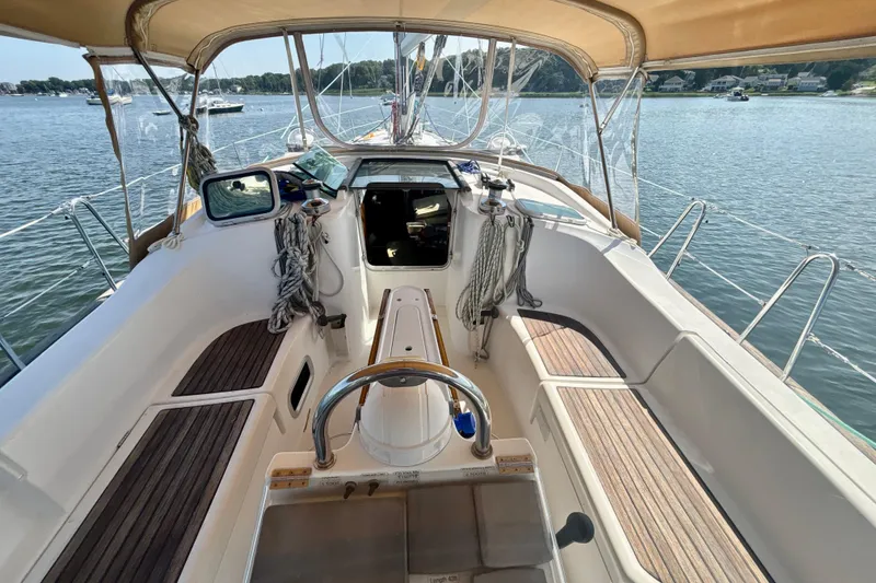Slide: The Image of 2004 Beneteau Oceanis 423 sailboat cockpit with teak seating and steering wheel. - 10