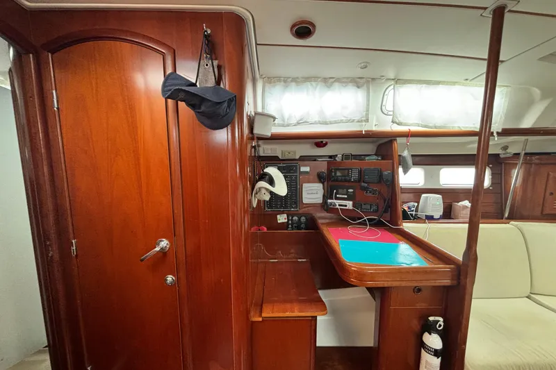 Slide: The Image of Interior of 2004 Beneteau Oceanis 423 sailboat with navigation station and wooden cabinetry. - 17