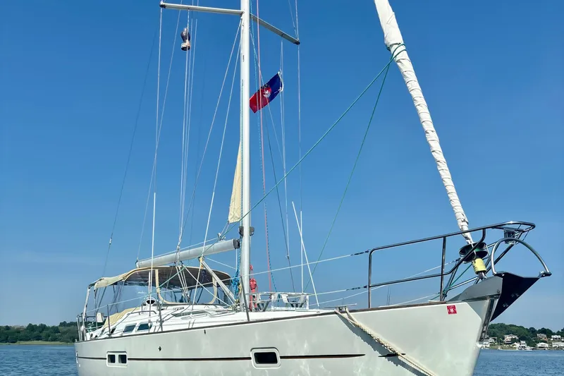 Slide: The Image of 2004 Beneteau Oceanis 423 sailboat on calm water under clear blue sky. - 2