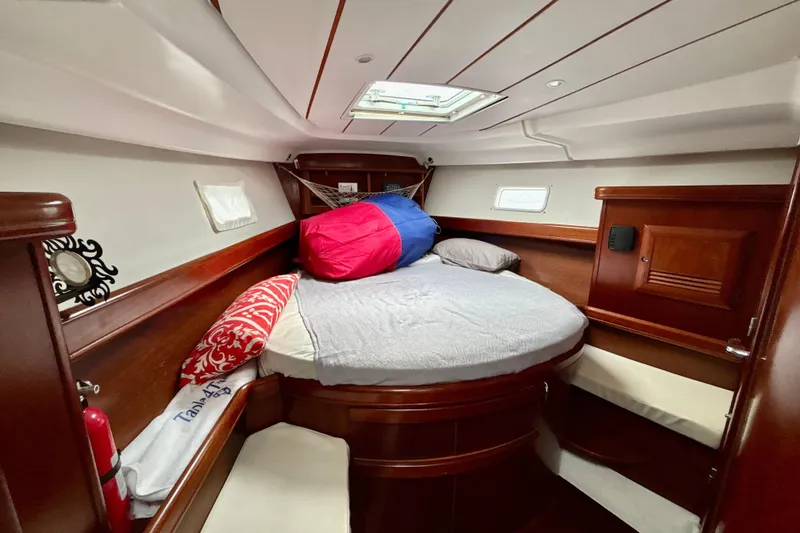 Slide: The Image of Cozy cabin interior of 2004 Beneteau Oceanis 423 sailboat with wood finish and bedding. - 22