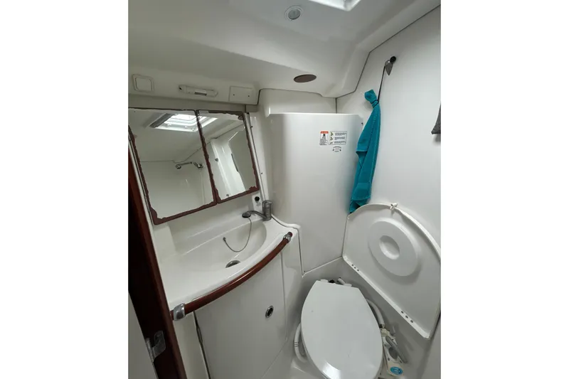 Slide: The Image of Bathroom interior of 2004 Beneteau Oceanis 423 yacht, featuring sink and toilet. - 24