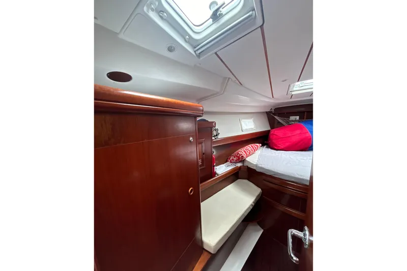 Slide: The Image of Cozy cabin interior of 2004 Beneteau Oceanis 423 sailboat with wooden finish and bedding. - 25