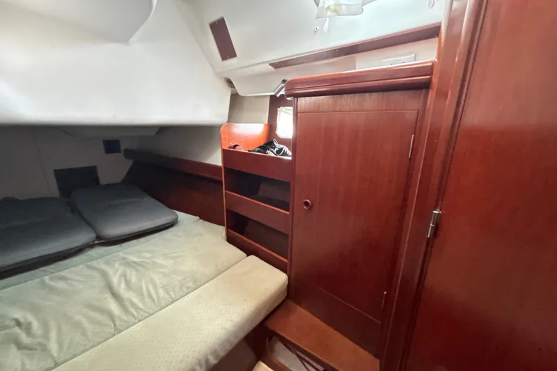 Slide: The Image of Cozy cabin interior of 2004 Beneteau Oceanis 423 sailboat with wooden furnishings. - 27