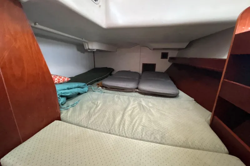 Slide: The Image of Cozy cabin interior of 2004 Beneteau Oceanis 423 sailboat with bedding and storage. - 28