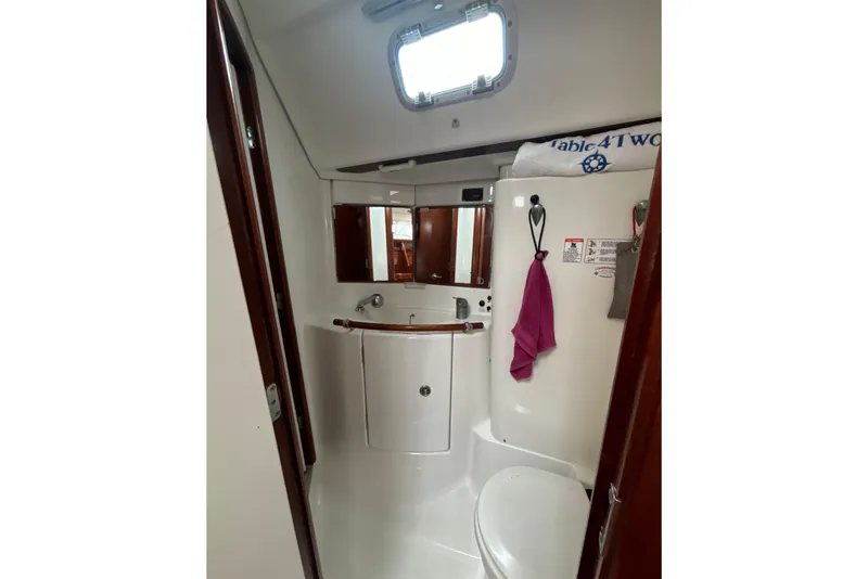 Slide: The Image of Bathroom interior of 2004 Beneteau Oceanis 423 yacht, featuring sink and mirror. - 29