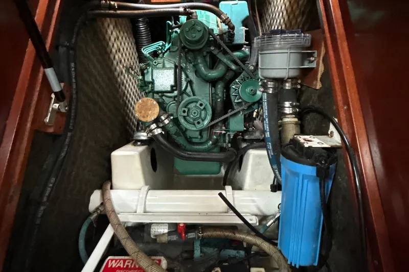 Slide: The Image of Engine compartment of a 2004 Beneteau Oceanis 423 sailboat, showcasing mechanical components. - 30