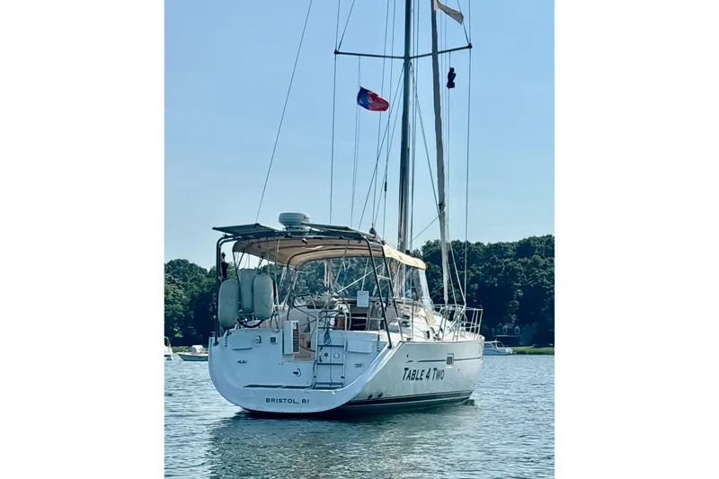 Slide: The Image of 2004 Beneteau Oceanis 423 sailboat anchored on calm water, rear view. - 4