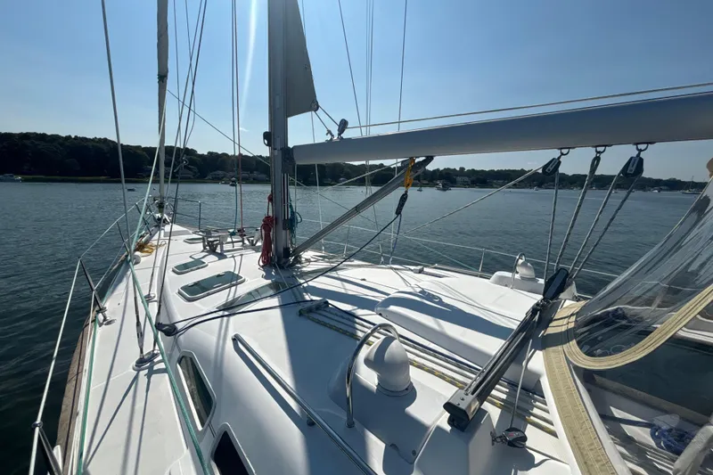 Slide: The Image of 2004 Beneteau Oceanis 423 sailboat on calm water, showcasing deck and rigging. - 6