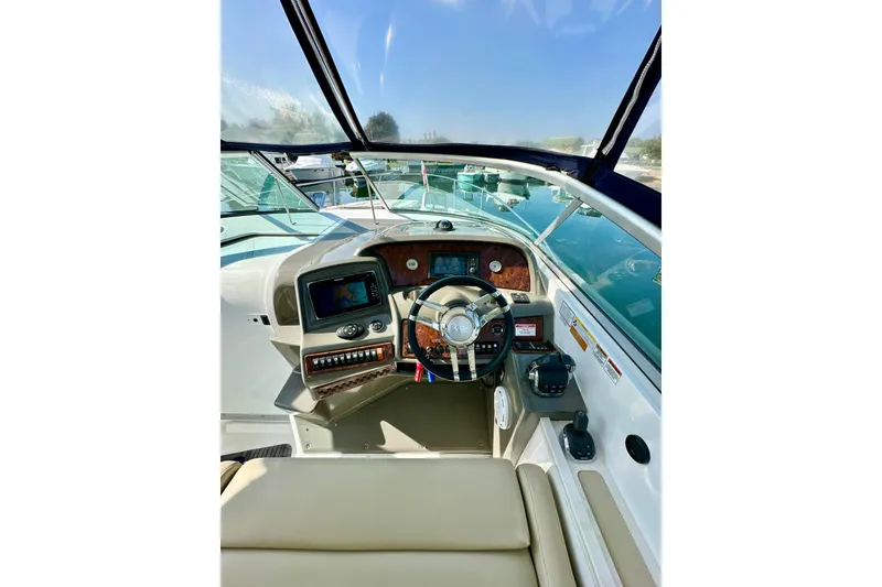 Slide: The Image of 2015 Rinker 340 Express Cruiser helm with modern controls and navigation system. - 12