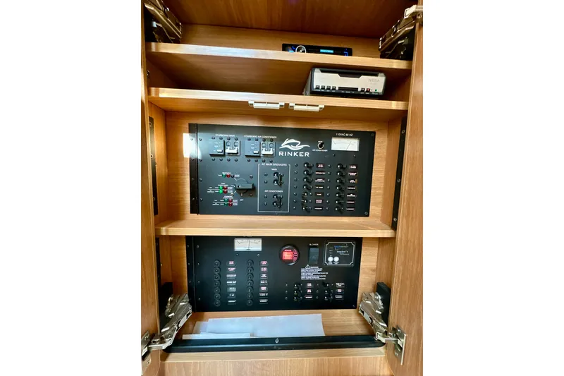 Slide: The Image of Electrical panel of 2015 Rinker 340 Express Cruiser, featuring control switches and circuit breakers. - 28