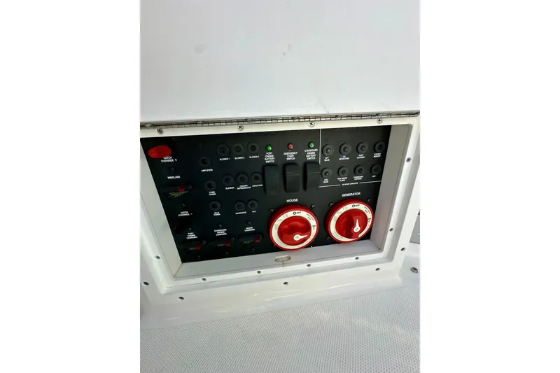 Slide: The Image of Control panel of a 2015 Rinker 340 Express Cruiser boat with switches and dials. - 29