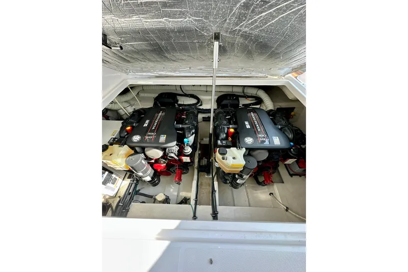 Slide: The Image of Engine compartment of a 2015 Rinker 340 Express Cruiser with dual engines. - 31