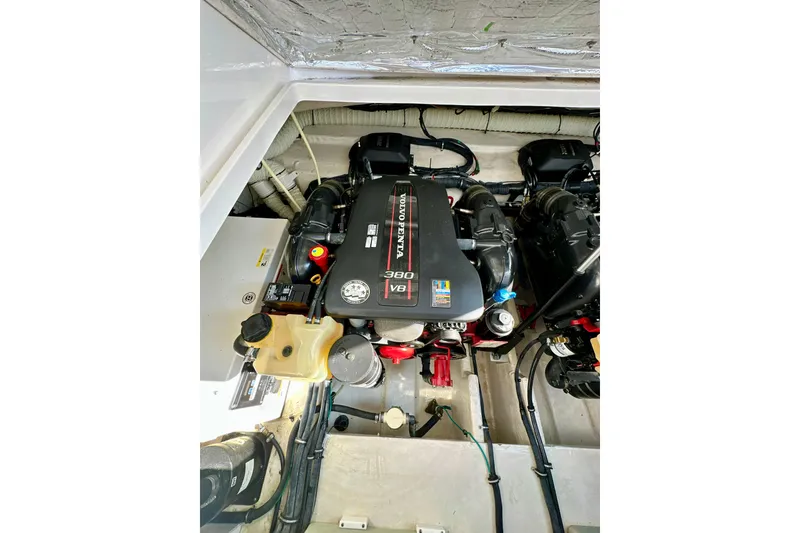 Slide: The Image of Engine compartment of 2015 Rinker 340 Express Cruiser, featuring a Volvo Penta V8 engine. - 32