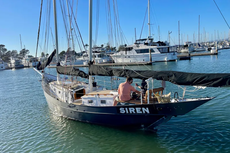 Slide: The Image of Sailboat "Siren" by Pinky, Custom model, 2008, docked in a marina under clear skies. - 10