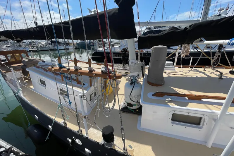 Slide: The Image of Sailboat docked at marina, Pinky Custom model, 2008, with visible rigging and deck details. - 11