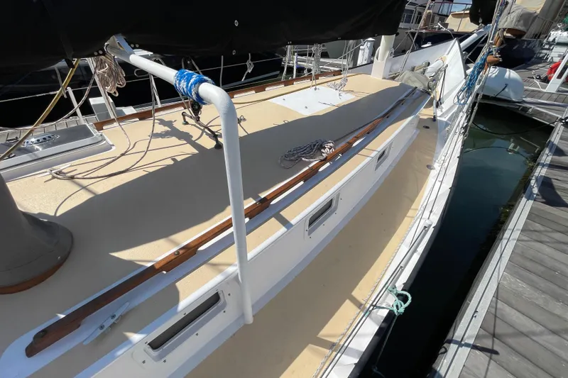 Slide: The Image of Sailboat deck view, Pinky Custom 2008 model, docked at marina with ropes and equipment. - 12