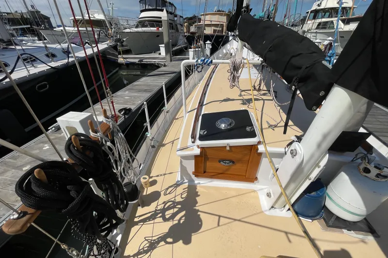 Slide: The Image of Sailboat deck view, Pinky Custom 2008, docked at marina with ropes and equipment. - 13