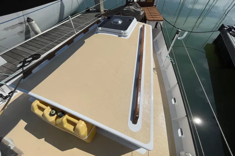 Slide: The Image of Deck of 2008 Pinky Custom boat with wooden rail and yellow containers. - 14
