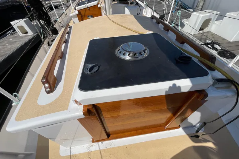Slide: The Image of 2008 Pinky Custom boat deck with wooden accents and a central hatch. - 23