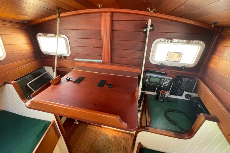 Slide: The Image of Wooden interior of 2008 Pinky Custom boat with navigation equipment and foldable table. - 26