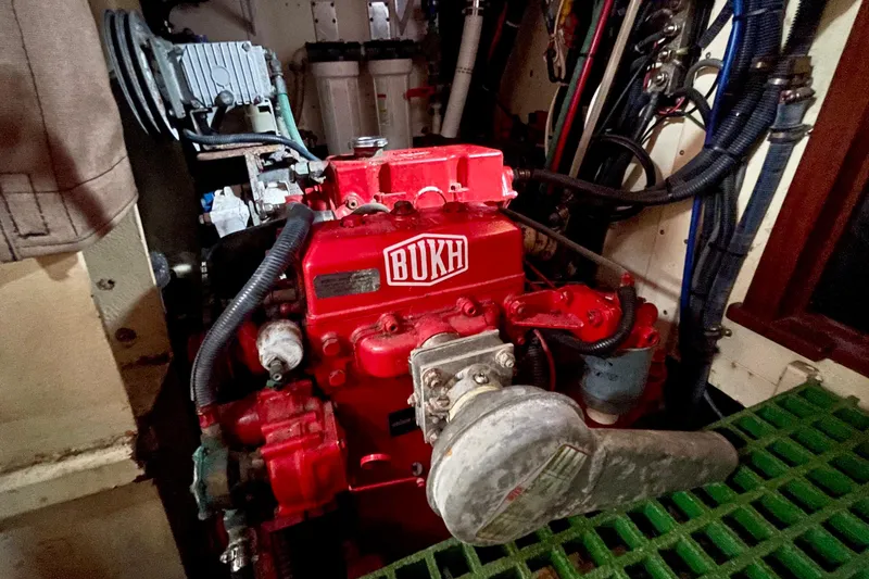 Slide: The Image of Red BUKH engine in a 2008 Pinky Custom boat, surrounded by cables and machinery. - 29
